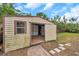 Outdoor storage shed with a single window and open door, offering ample storage space at 6327 5Th Street E Cir, Bradenton, FL 34203