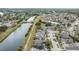 Aerial view showcasing a neighborhood near a waterway, featuring numerous houses and canals at 6931 Silvermill Dr, Tampa, FL 33635