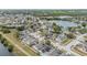 Aerial view of a residential neighborhood with houses clustered around a lake at 6931 Silvermill Dr, Tampa, FL 33635