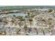 Aerial view of a residential neighborhood with houses and a lake at 6931 Silvermill Dr, Tampa, FL 33635