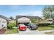 House exterior featuring a two-car garage and landscaping at 6931 Silvermill Dr, Tampa, FL 33635