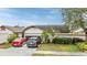 House exterior featuring a two-car garage and well-maintained landscaping at 6931 Silvermill Dr, Tampa, FL 33635