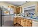 Kitchen with stainless steel refrigerator and wood cabinets at 6931 Silvermill Dr, Tampa, FL 33635