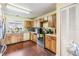 View of kitchen with wood cabinets, appliances, and hardwood floors at 6931 Silvermill Dr, Tampa, FL 33635