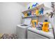 Practical laundry room with washer, dryer, and shelving at 6931 Silvermill Dr, Tampa, FL 33635