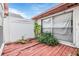 Small patio with wooden deck and overgrown plants at 6931 Silvermill Dr, Tampa, FL 33635