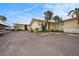 Front view of condo building, showing parking and landscaping at 7300 Sunshine Skyway S Ln # 108, St Petersburg, FL 33711