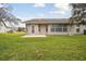 Backyard view of home with patio and grassy area at 7473 Willow Brook Dr, Spring Hill, FL 34606