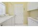 Laundry room with washer, dryer, and built-in sink at 7473 Willow Brook Dr, Spring Hill, FL 34606