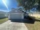 Two-story house with attached garage and landscaping at 7533 Merchantville Cir, Zephyrhills, FL 33540