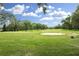 Golf course fairway view on a sunny day, featuring a sand trap at 7724 St Andrews Blvd, Weeki Wachee, FL 34613