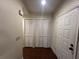 Hallway with a wood floor, a front door and two sets of closet doors at 7724 St Andrews Blvd, Weeki Wachee, FL 34613