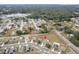 Wide aerial view showing home and surrounding community at 7943 Merchantville Cir, Zephyrhills, FL 33540