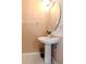 Small bathroom with pedestal sink, mirror and simple design at 8811 Casablanca Way # 106, Tampa, FL 33626