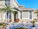 Front entrance of a house with palm trees and stone pathway at 8811 Casablanca Way # 106, Tampa, FL 33626