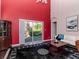 Living room with red accent wall and sliding glass doors to backyard at 8811 Casablanca Way # 106, Tampa, FL 33626