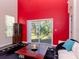 Living room with red accent wall and sliding glass doors to backyard at 8811 Casablanca Way # 106, Tampa, FL 33626