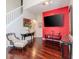 Living room with hardwood floors, a red accent wall, and comfortable seating at 8811 Casablanca Way # 106, Tampa, FL 33626