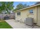 Concrete patio with grill, AC unit, and seating at 9070 Bryan Dairy Rd, Seminole, FL 33777