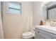 Clean bathroom with gray vanity, shower, and white toilet at 9070 Bryan Dairy Rd, Seminole, FL 33777