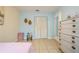 Bedroom with pink bedding, dresser, and window with blinds at 9070 Bryan Dairy Rd, Seminole, FL 33777