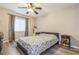 Bedroom with floral bedding, nightstand, and ceiling fan at 9070 Bryan Dairy Rd, Seminole, FL 33777