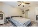 Bedroom with floral bedding, nightstand and ceiling fan at 9070 Bryan Dairy Rd, Seminole, FL 33777