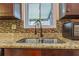 Kitchen featuring a granite countertop, double sink, and dark brown cabinets at 9070 Bryan Dairy Rd, Seminole, FL 33777