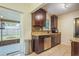 Kitchen with dark brown cabinets, granite countertops, and stainless steel appliances at 9070 Bryan Dairy Rd, Seminole, FL 33777