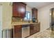 Kitchen with dark brown cabinets, granite countertops, and stainless steel appliances at 9070 Bryan Dairy Rd, Seminole, FL 33777