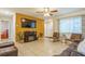 Living room featuring a TV, electric fireplace, and brown leather furniture at 9070 Bryan Dairy Rd, Seminole, FL 33777