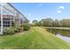 Landscaped backyard with lake view at 9144 Highland Ridge Way, Tampa, FL 33647