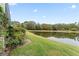 Landscaped backyard with lake view at 9144 Highland Ridge Way, Tampa, FL 33647