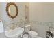 Powder room with ornate mirror and decorative border at 9144 Highland Ridge Way, Tampa, FL 33647