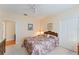 Comfortable bedroom with floral bedding and access to hallway at 9144 Highland Ridge Way, Tampa, FL 33647