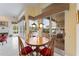 Bright breakfast nook with wood table and chairs, and view to pool area at 9144 Highland Ridge Way, Tampa, FL 33647