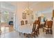 Elegant dining room with chandelier and wood table at 9144 Highland Ridge Way, Tampa, FL 33647