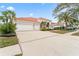 Tan house with tile roof and three-car garage at 9144 Highland Ridge Way, Tampa, FL 33647