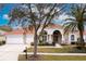 Mediterranean style home with tile roof and landscaping at 9144 Highland Ridge Way, Tampa, FL 33647