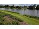 Picturesque lakefront view with homes and lush greenery at 9144 Highland Ridge Way, Tampa, FL 33647