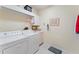 Laundry room with washer, dryer, and cabinets at 9144 Highland Ridge Way, Tampa, FL 33647