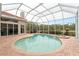 Relaxing kidney-shaped pool and spa with a screened enclosure at 9144 Highland Ridge Way, Tampa, FL 33647