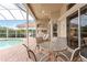 Relaxing pool area with patio furniture and screened enclosure at 9144 Highland Ridge Way, Tampa, FL 33647