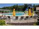 Community pool with lounge chairs and umbrellas at 9144 Highland Ridge Way, Tampa, FL 33647