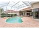 Large kidney shaped pool with a screened patio area at 9144 Highland Ridge Way, Tampa, FL 33647