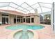 Inviting screened pool and spa area at 9144 Highland Ridge Way, Tampa, FL 33647