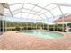 Inviting kidney-shaped pool with a screened enclosure at 9144 Highland Ridge Way, Tampa, FL 33647