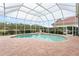 Relaxing kidney-shaped pool with screened enclosure at 9144 Highland Ridge Way, Tampa, FL 33647