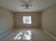 Bright bedroom featuring tile floors and ceiling fan at 9521 Grovedale Cir # 201, Riverview, FL 33578