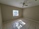 Spacious bedroom with tile flooring and a ceiling fan at 9521 Grovedale Cir # 201, Riverview, FL 33578